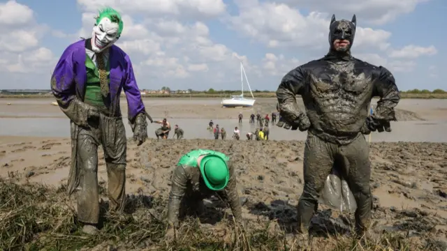 Competitors dressed as Batman characters participate in the Maldon Mud Race