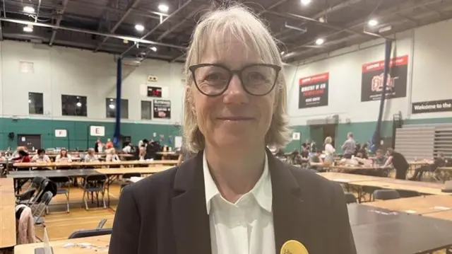 Sally Symington standing in a hall where an election count is taking place
