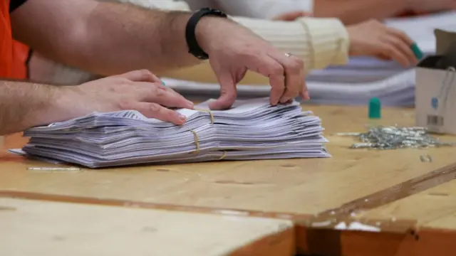 Ballot papers on a table being couted