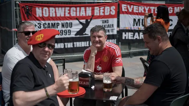 Fans of Manchester United enjoy the pre-match atmosphere