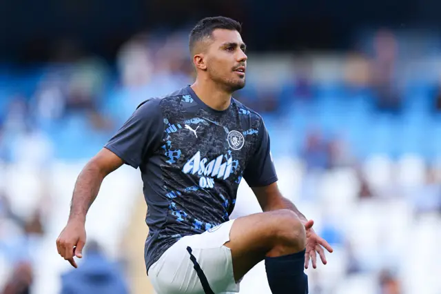 Rodri of Manchester City warms up on his return from injury