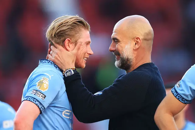 Pep Guardiola, Manager of Manchester City, embraces Kevin De Bruyne of Manchester City after the Premier League match between Manchester United FC and Manchester City FC at Old Trafford on April 06, 2025 in Manchester, England.