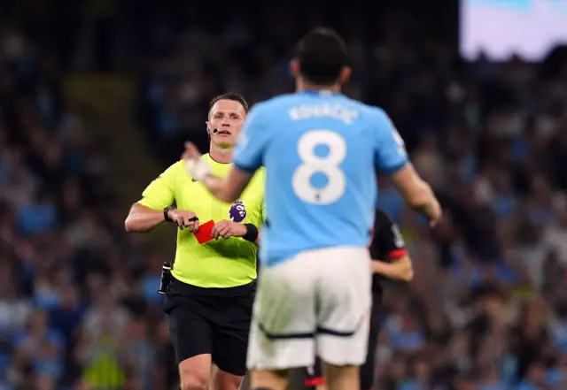 Referee Thomas Bramall shows a red card to Manchester City's Mateo Kovacic