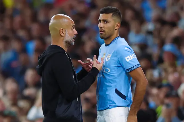 Rodri of Manchester City with Pep Guardiola manager of Manchester City as he makes he return from injury