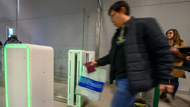 A passenger walking through an e-gate in a Portuguese airport (file image)
