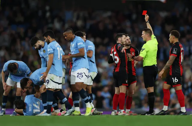 AFC Bournemouth's Lewis Cook is shown a red card by referee Thomas Bramal
