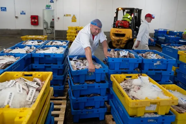 Buyers remove their purchased fresh fish in the Auction Hall of Grimsby Fish Market in Grimsby