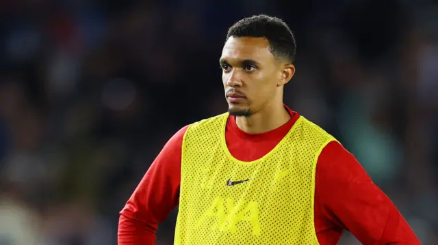 Trent Alexander-Arnold looks at the Liverpool fans after being an unused substitute for the team's defeat at Brighton