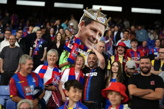 Crystal Palace fans hold up a cut out of manager Oliver Glasner ahead of the Premier League match at Selhurst Park, London.