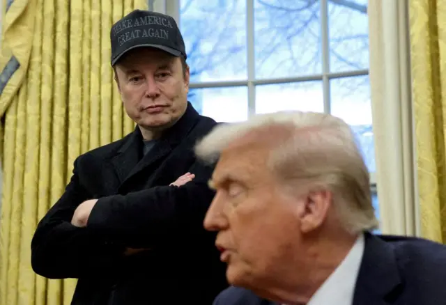 Elon Musk listens to US President Donald Trump speak in the Oval Office