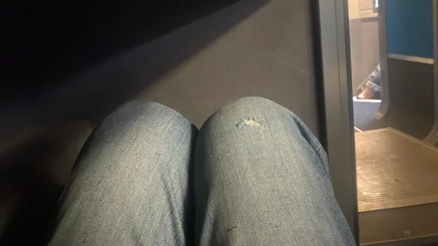 Picture of someone sitting on the floor on the Eurostar