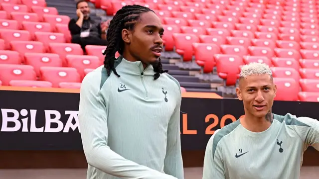 Djed Spence and Richarlison walk onto the pitch