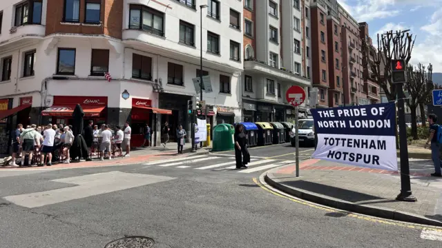 Street in Bilbao with fans and a Tottenham flag