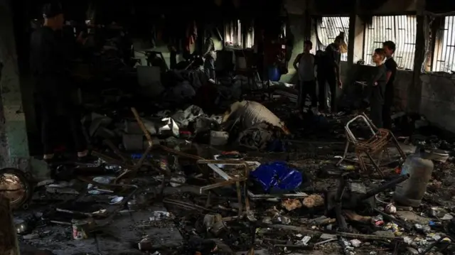 Palestinians at the site of an Israeli air strike in Gaza City on Tuesday