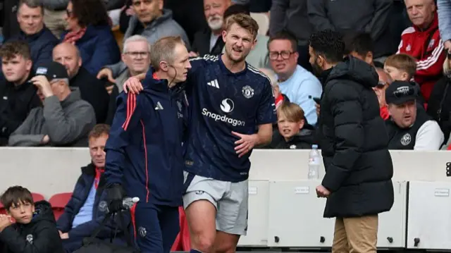 Manchester United defender Matthijs de Ligt limps off with an injury