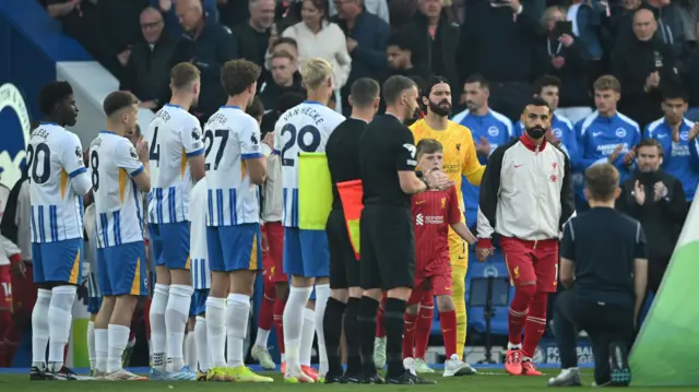 Brighton players give Premier League champions Liverpool a guard of honour before their game on 19 May 2025