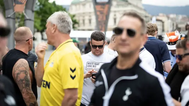 Supporters walk though the fan zone