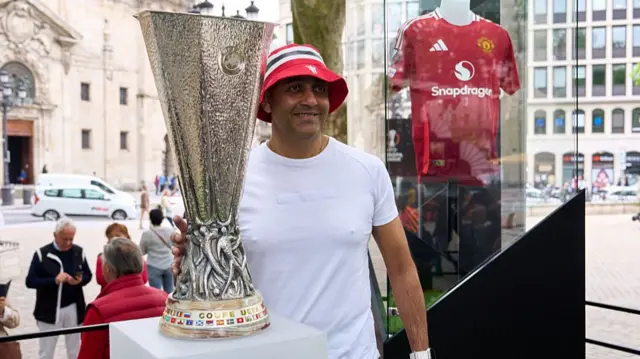 Manchester United fan with the Europa League trophy