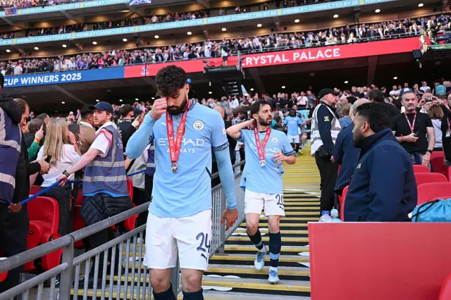Josko Gvardiol and Bernardo Silva look dejected after collecting their medals after losing the Emirates FA Cup Final match between Crystal Palace and Manchester City at Wembley Stadium on May 17, 2025 in London, England.