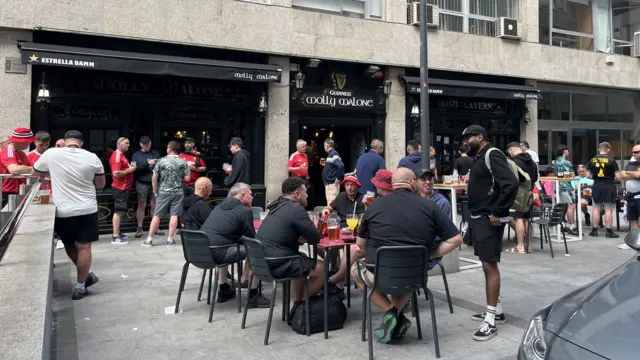 Manchester United fans gather outside a pub in Bilbao