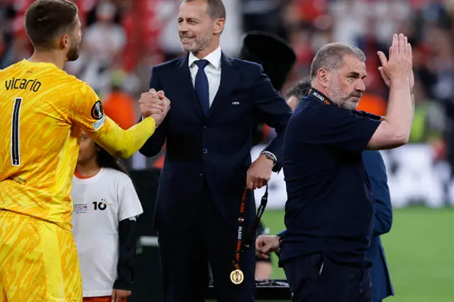 Tottenham Hotspur's Greek-Australian Head Coach Ange Postecoglou (R) claps