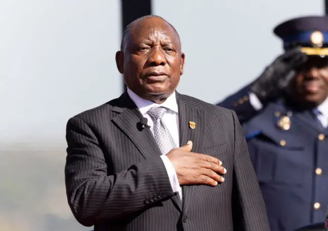 Ramaphosa with his hand on his chest