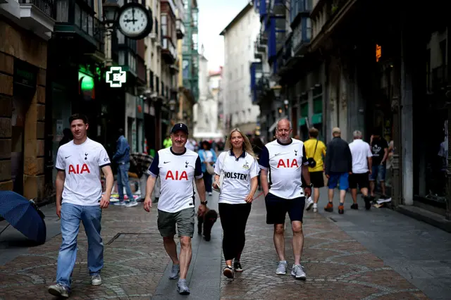 Spurs fans walk through the streets of Bilbao