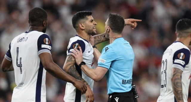 Tottenham Hotspur's Cristian Romero reacts with referee Felix Zwayer