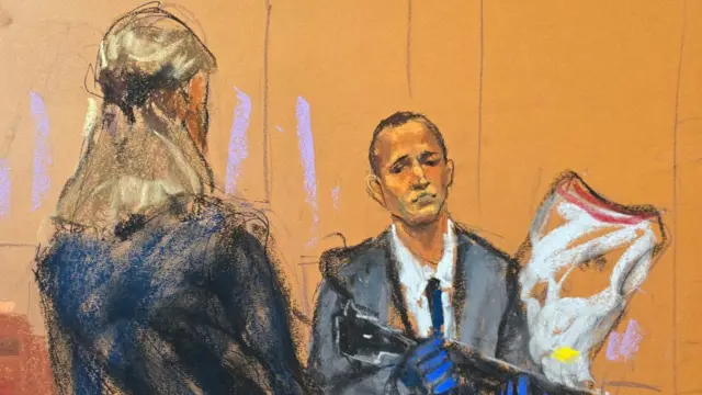 A court sketch of Prosecutor Madison Smizer questioning Homeland Security Investigations Special Agent Gerard Gannon as he holds an evidence bag of the upper receivers of AR-15 rifles recovered during a search