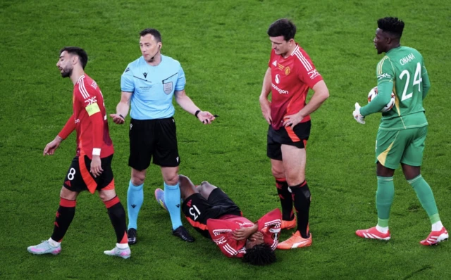 Manchester United's Patrick Dorgu lies injured