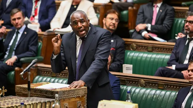 David Lammy speaks at the dispatch box in the House of Commons and gestures