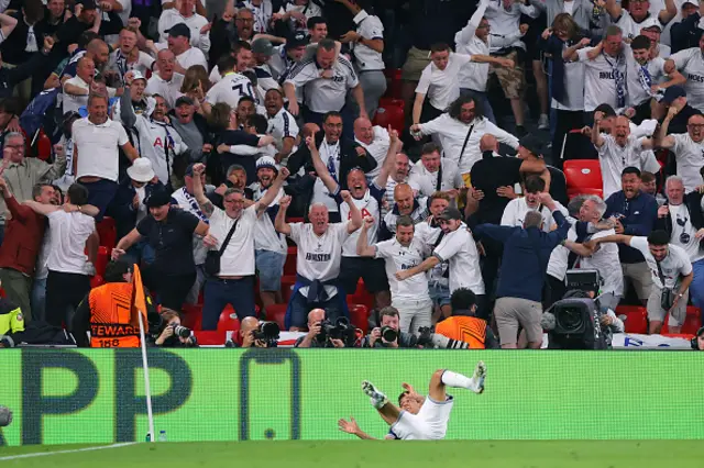 Supporters of Tottenham Hotspur celebrate after Brennan Johnson (ground) celebrates