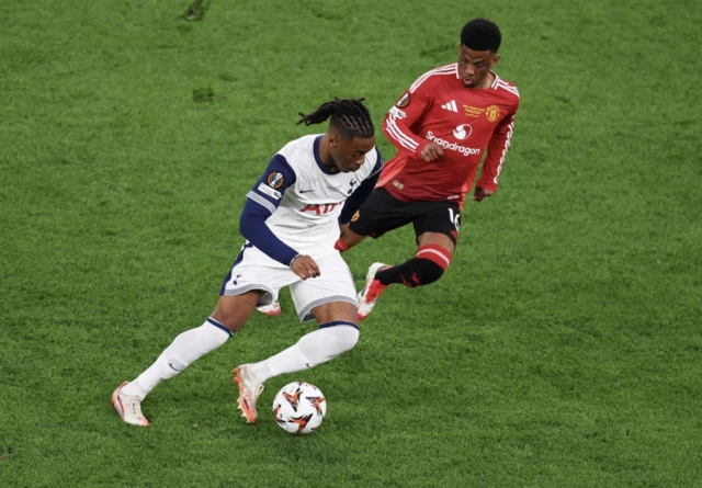 Tottenham Hotspur's Destiny Udogie in action with Manchester United's Amad Diallo