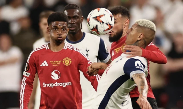 Tottenham Hotspur's Richarlison in action with Manchester United's Noussair Mazraoui and Amad Diallo