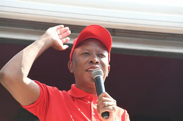 Julius Malema, dressed in red, speaks at a rally in Pretoria on 19 May 2025