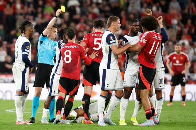 Harry Maguire is shown a yellow card by German referee Felix Zwayer