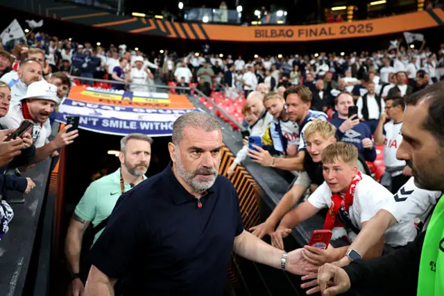 Ange Postecoglou, Manager of Tottenham Hotspur, shakes hands with fans