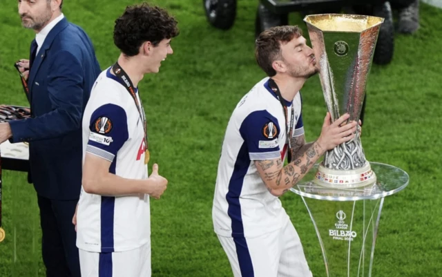 Tottenham Hotspur's James Maddison kisses the trophy