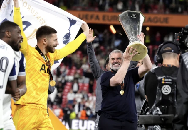Tottenham Hotspur manager Ange Postecoglou celebrates with the trophy