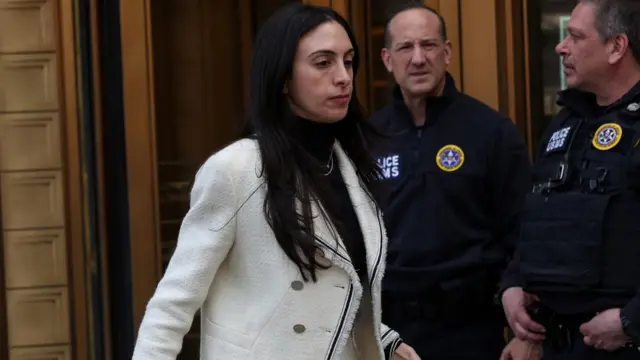 Sean "Diddy" Combs lawyer Teny Geragos departs court. She is wearing a white jacket over a black turtleneck.