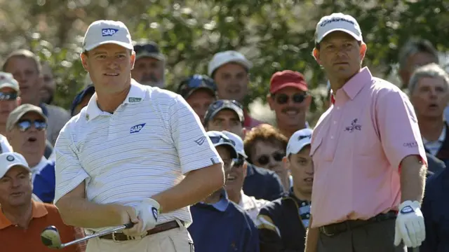 South Africa's Ernie Els (L) hits a tee shot as fellow countryman Retief Goosen looks on during a golf match.