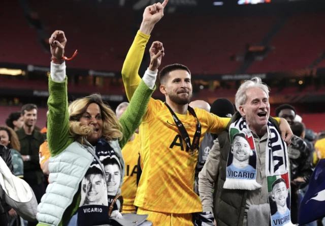 Tottenham Hotspur goalkeeper Guglielmo Vicario (centre) celebrates with his mother Monica (left) and father Michele