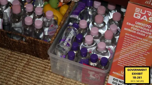 Bottles of baby oil are stacked in plastic containers