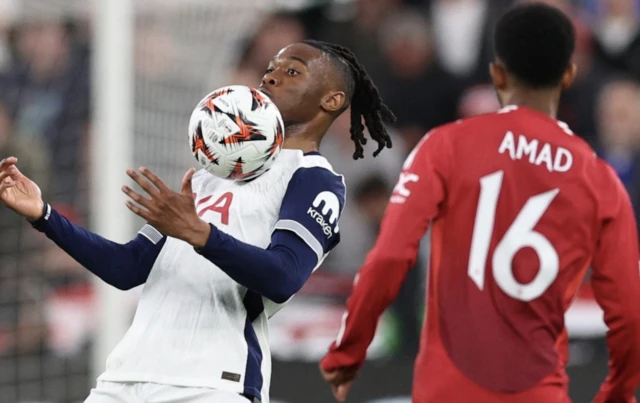 Tottenham Hotspur's Destiny Udogie in action with Manchester United's Amad Diallo R
