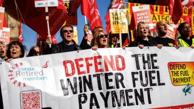 Protesters hold placards and a banner while campaigning for the reversal of the winter fuel payment cuts to pensioners, which is proposed by the British government, at Old Palace Yard, in London, Britain, 07 October 2024.