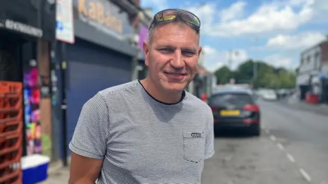Daniel Pastusiak standing in a street, wearing a t-shirt