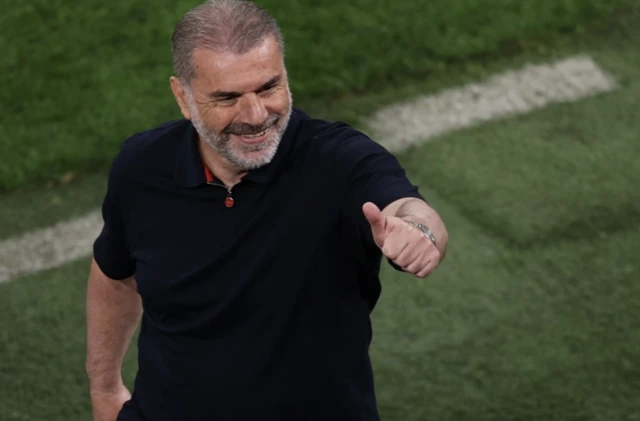 Tottenham Hotspur manager Ange Postecoglou gestures to the fans