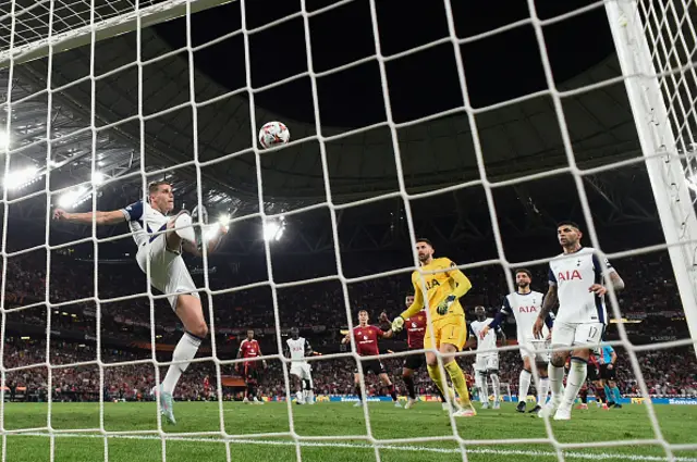 Micky van de Ven clears the ball