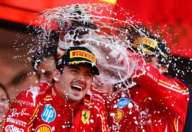 Charles Leclerc has champagne poured over him after winning his home race in Monaco