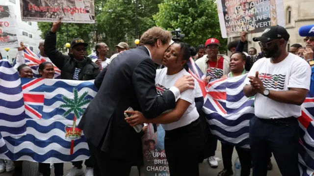 Deputy Leader of Reform UK Richard Tice embraces a member of the British Chagossian community as they wait to hear the outcome of a court injunction